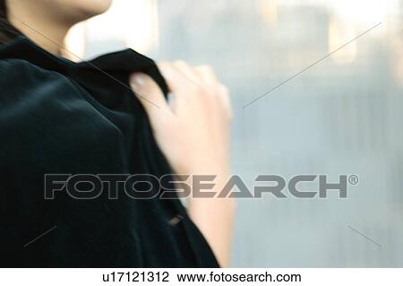 Stock Image - A young woman in a coat, close-up. Fotosearch