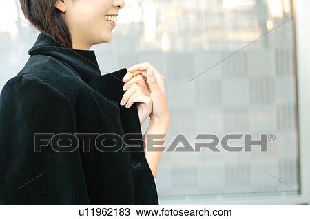 Stock Image - A young woman in a coat. Fotosearch