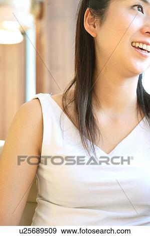 Stock Photo - A young woman smiling. Fotosearch