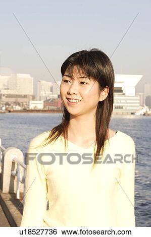Stock Photograph - A young woman smiling. Fotosearch