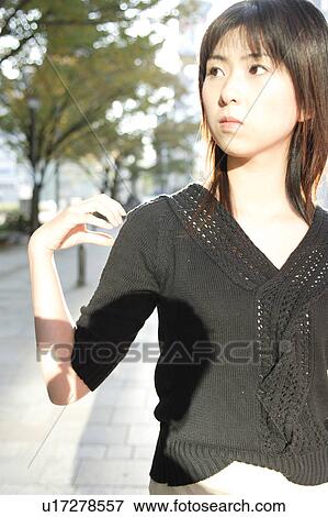 A young woman walking View Large Photo Image Stock Photo - A young woman walking. Fotosearch