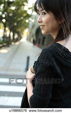 Stock Photograph - A young woman walking. Fotosearch