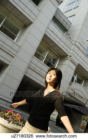 A young woman walking View Large Photo Image Stock Photograph - A young woman walking. Fotosearch