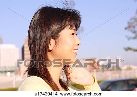 Picture - Profile of a young woman smiling. Fotosearch