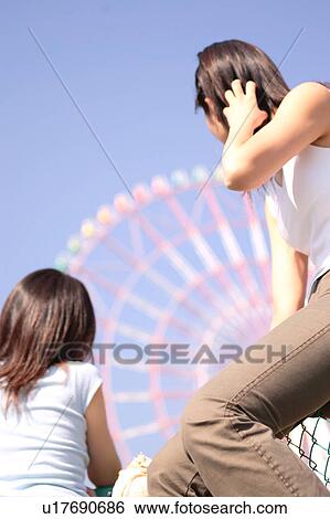 Stock Photograph - Two women Ferris wheel. Fotosearch
