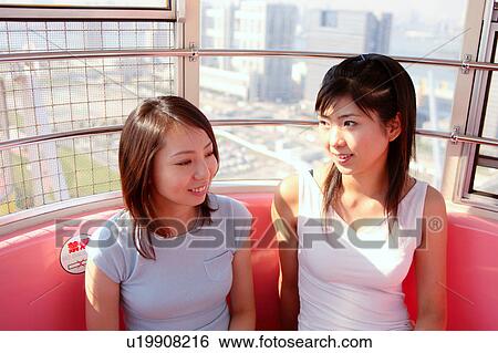 Stock Photograph - Two women in Ferris Wheel. Fotosearch
