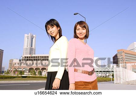 Two women standing View Large Photo Image Picture - Two women standing. Fotosearch