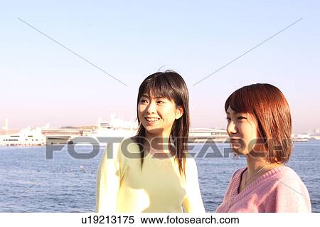 Stock Photography - Two women standing. Fotosearch
