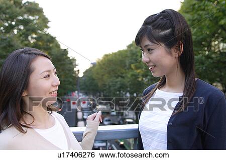 Stock Photograph - Two women talking. Fotosearch
