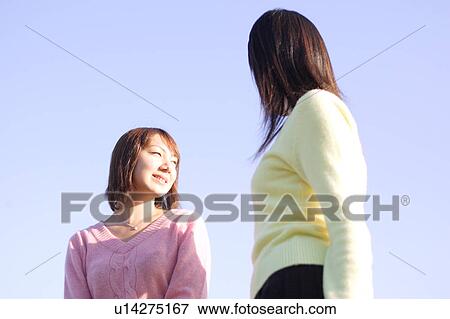 Stock Photo - Two young women standing. Fotosearch
