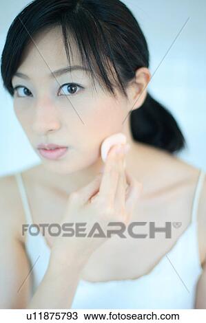 A young woman applying makeup View Large Photo Image Stock Image - A young woman applying makeup. Fotosearch