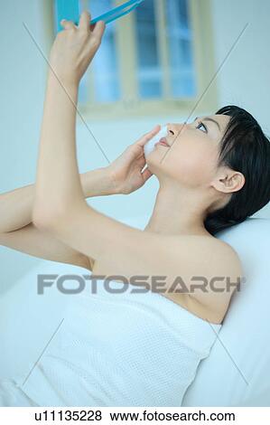 A young woman holding mirror with puff View Large Photo Image Stock Photo - A young woman holding mirror with puff. Fotosearch