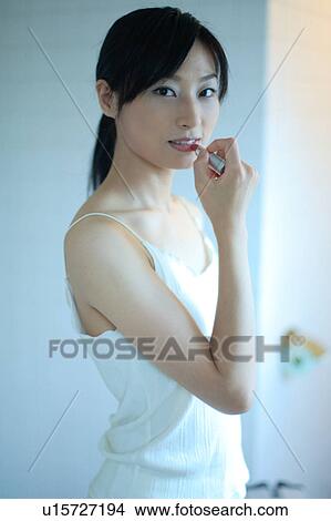 A young woman wearing lipstick View Large Photo Image Picture - A young woman wearing lipstick. Fotosearch