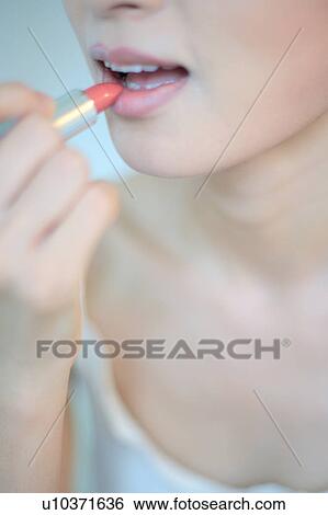 Profile of a young woman wearing lipstick View Large Photo Image Stock Photograph - Profile of a young woman wearing lipstick. Fotosearch