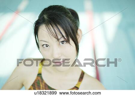 Stock Photo - Portrait of a young woman at poolside. Fotosearch