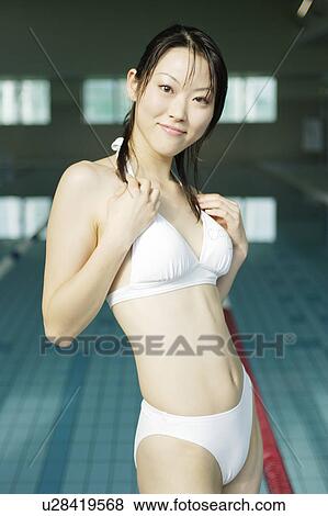 Stock Photo - Portrait of a young woman at poolside. Fotosearch