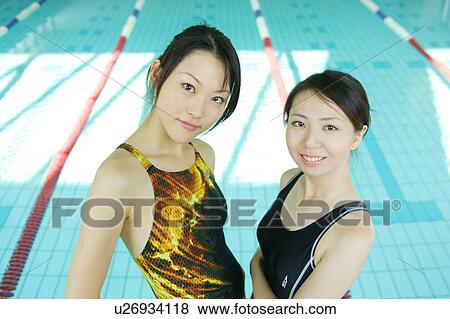 Stock Photo - Portrait of two young women at poolside. Fotosearch