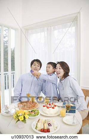 Family celebrating birthday at home View Large Photo Image Stock Image - Family celebrating birthday at home. Fotosearch