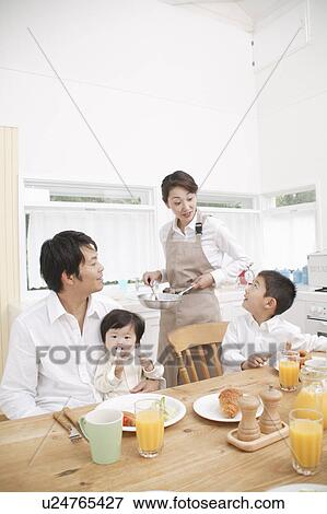 Stock Photo - Family eating breakfast. Fotosearch