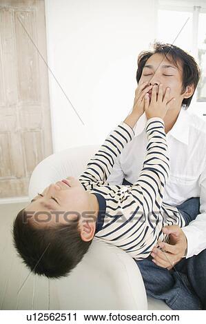Stock Image - Father and son having fun together. Fotosearch