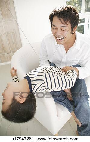 Father and son having fun together View Large Photo Image Stock Image - Father and son having fun together. Fotosearch
