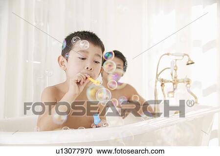 Father and son playing with bubbles in bathroom View Large Photo Image Stock Image - Father and son playing with bubbles in bathroom. Fotosearch
