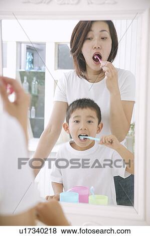 Mother and son brushing teeth View Large Photo Image Stock Photo - Mother and son brushing teeth. Fotosearch