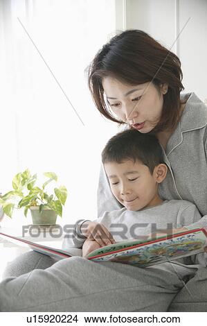 Picture - Mother and son reading a book. Fotosearch
