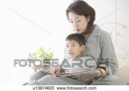 Mother and son reading a book View Large Photo Image Stock Image - Mother and son reading a book. Fotosearch
