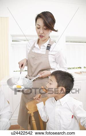 Stock Image - Mother cooking. Fotosearch
