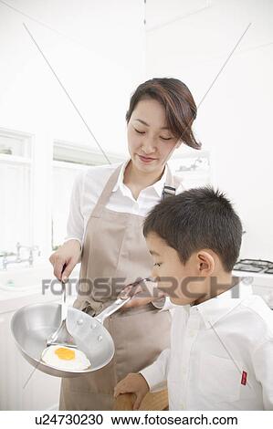Mother cooking View Large Photo Image Stock Image - Mother cooking. Fotosearch
