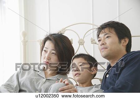 Mother, father and son sitting in bed View Large Photo Image Stock Image - Mother, father and son sitting in bed. Fotosearch
