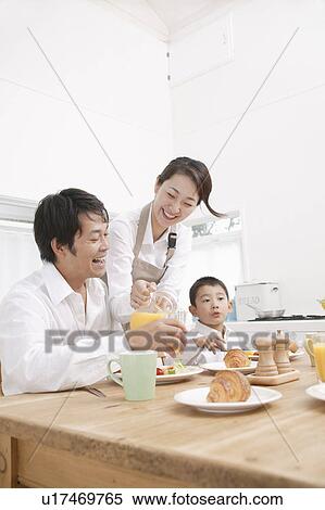 Mother serving son and father breakfast View Large Photo Image Stock Photography - Mother serving son and father breakfast. Fotosearch
