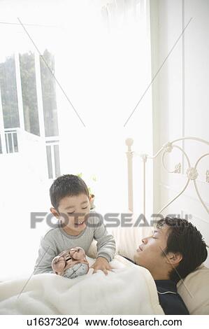 Son waking up father View Large Photo Image Picture - Son waking up father. Fotosearch