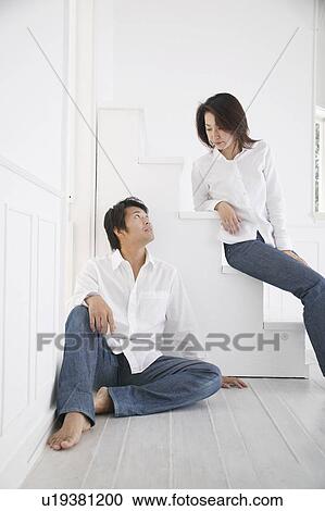 Stock Image - Adult couple talking face to face. Fotosearch