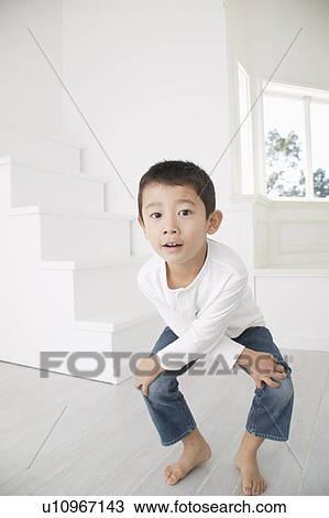 Stock Image - Boy squatting. Fotosearch
