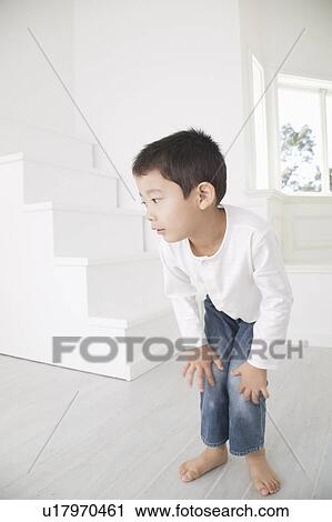 Stock Image - Boy squatting. Fotosearch