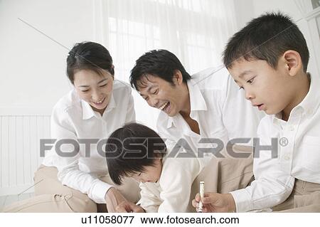 Stock Photo - Family playing with crayon. Fotosearch