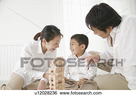 Stock Photograph - Family playing with toy. Fotosearch