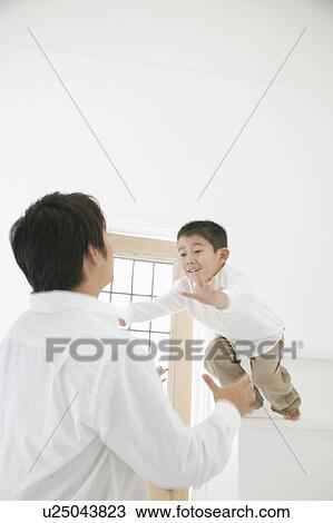 Stock Image - Son jumping to father. Fotosearch