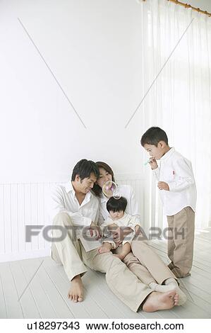 Son playing with bubbles and parents watching with smile. View Large Photo Image Stock Image - Son playing with bubbles and parents watching with smile.. Fotosearch