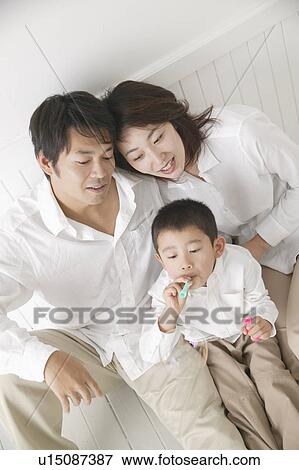 Son playing with bubbles and parents watching with smile. View Large Photo Image Stock Photo - Son playing with bubbles and parents watching with smile.. Fotosearch