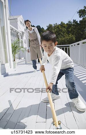Boy cleaning terrace with mop View Large Photo Image Stock Image - Boy cleaning terrace with mop. Fotosearch