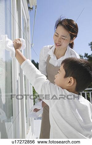 Boy cleaning window with cloth View Large Photo Image Stock Photograph - Boy cleaning window with cloth. Fotosearch