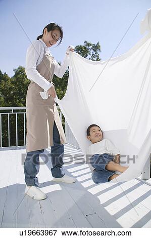 Stock Photo - Boy playing with sheet. Fotosearch