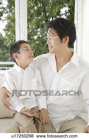 Father and son looking at camera with glasses View Large Photo Image Stock Photo - Father and son looking at camera with glasses. Fotosearch