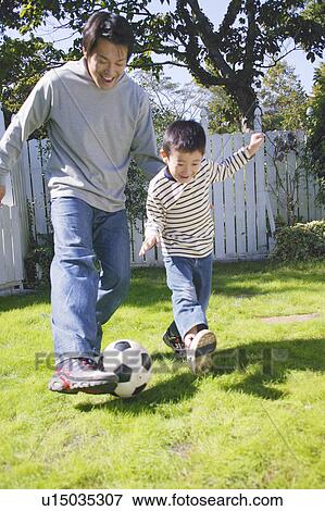 Father and son playing with ball View Large Photo Image Stock Photo - Father and son playing with ball. Fotosearch