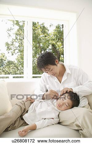 Father cleaning son's ear View Large Photo Image Stock Image - Father cleaning son's ear. Fotosearch