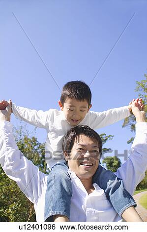 Father giving son piggyback View Large Photo Image Stock Photograph - Father giving son piggyback. Fotosearch