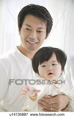 Stock Photo - Father holding baby girl. Fotosearch